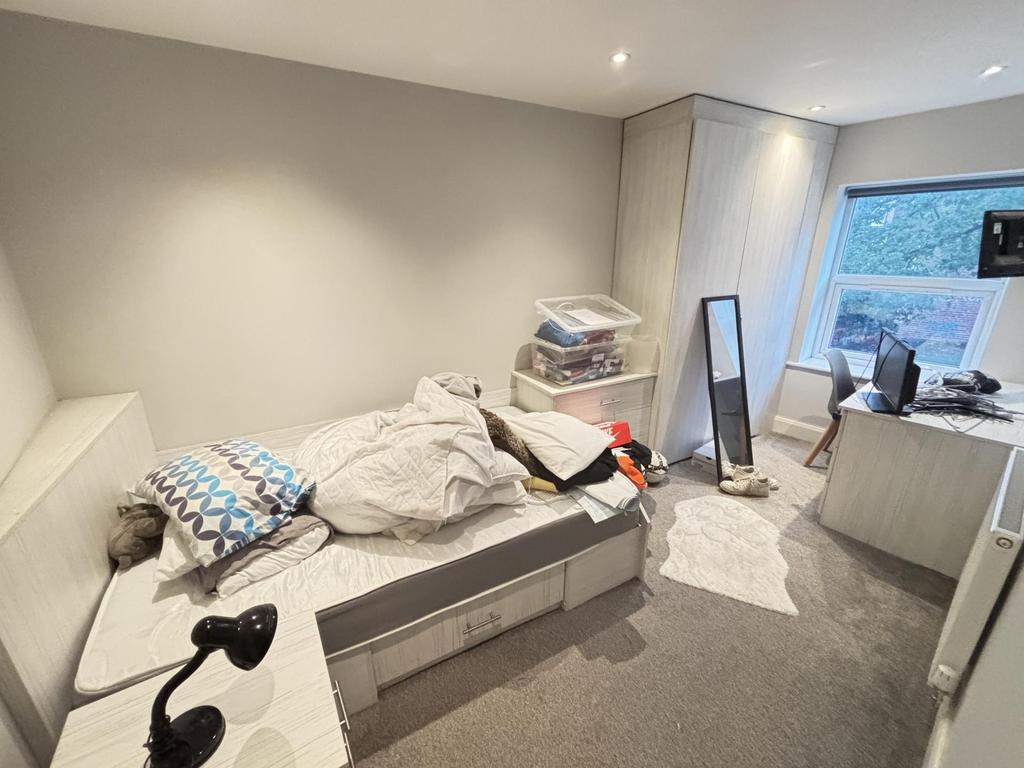 A cozy single bedroom with natural light coming...
