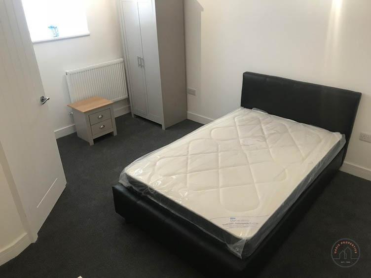 A tidy, well-maintained double bedroom featurin...