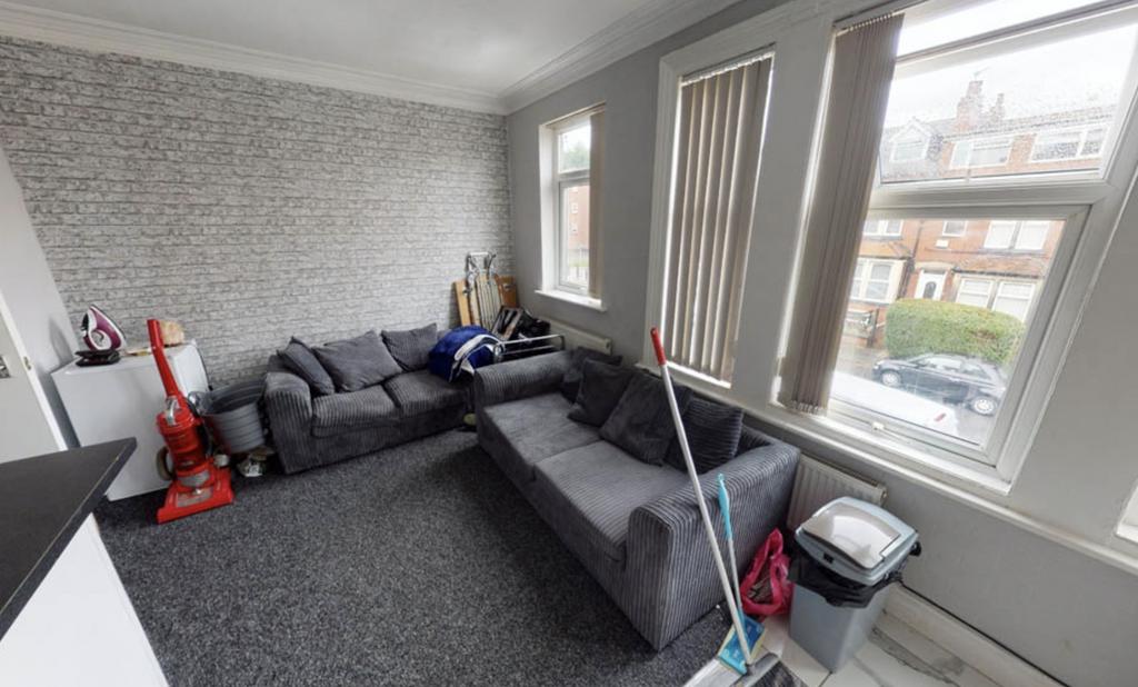 A spacious and well-lit contemporary living roo...