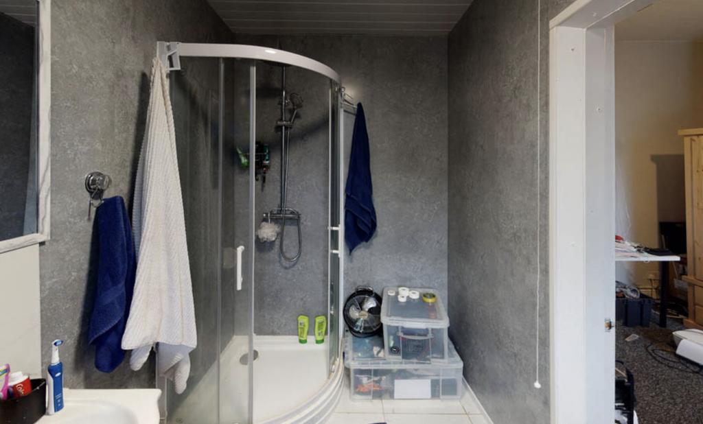 Bright and modern bathroom featuring a large sh...