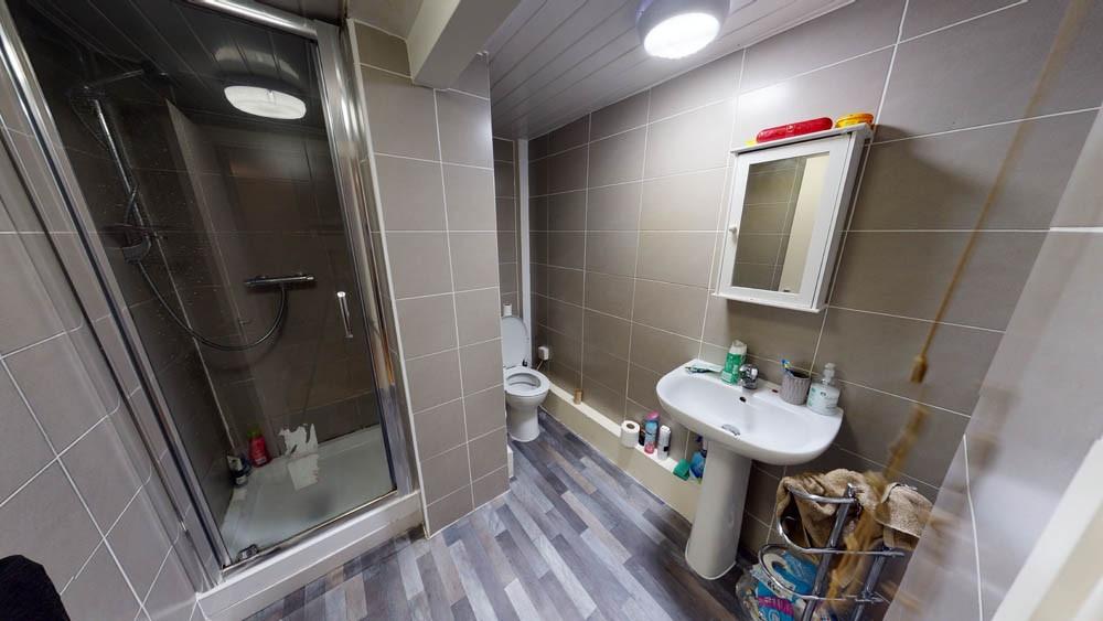 A clean and functional bathroom with a shower e...
