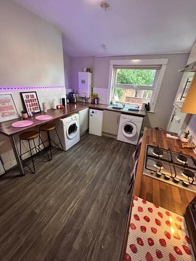 A bright and tidy kitchen with ample natural li...