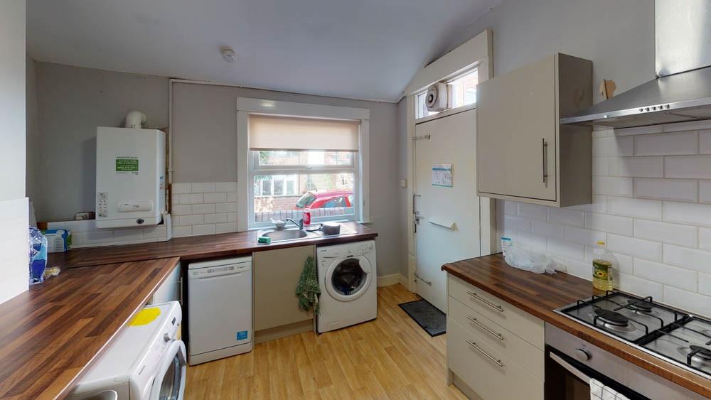 A bright and tidy kitchen with ample natural li...