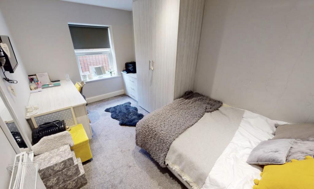 A cozy, well-maintained bedroom featuring a lar...