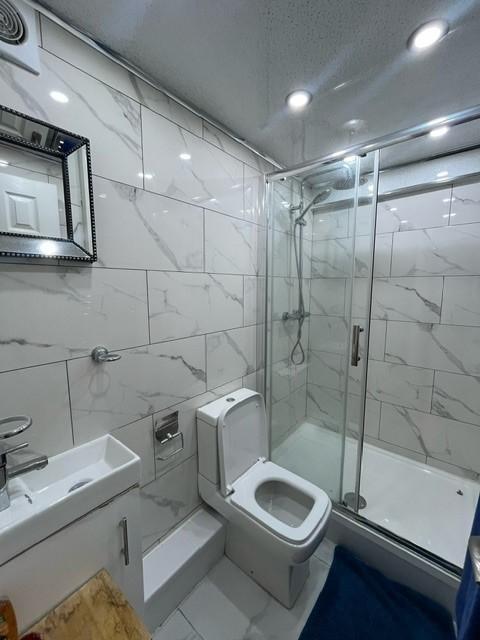 A modern and clean bathroom suite featuring a t...
