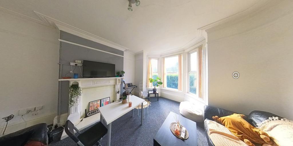 Bright and spacious living room featuring large...