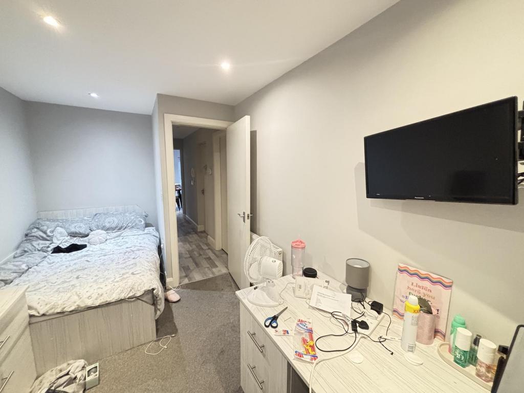 A bright and well-maintained bedroom featuring ...