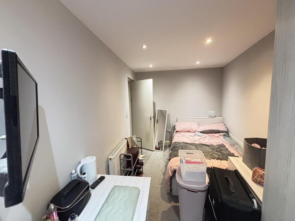 A cozy and well-maintained bedroom featuring tw...