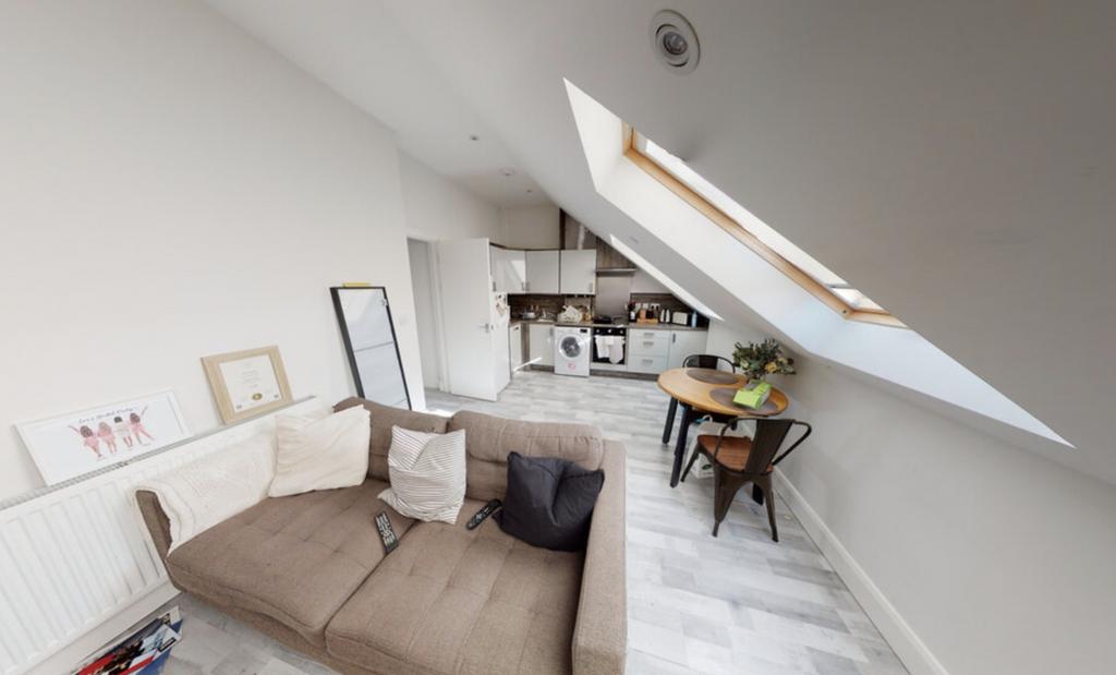 Bright and airy living room with large skylight...