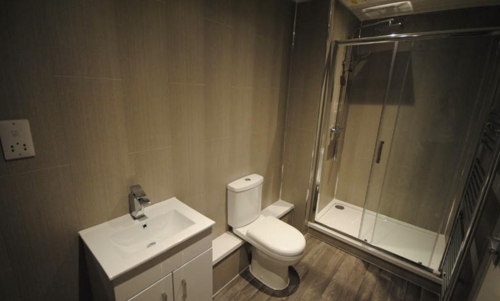 A modern, clean bathroom featuring a spacious s...