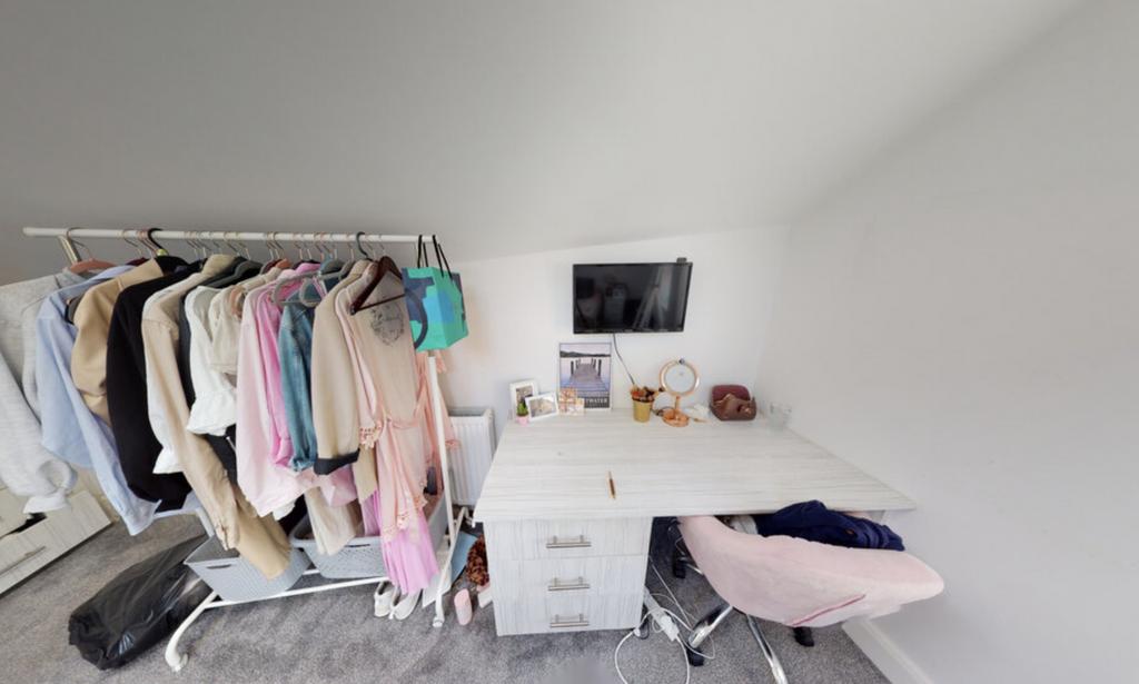 A bright and modern bedroom with a tidy layout,...