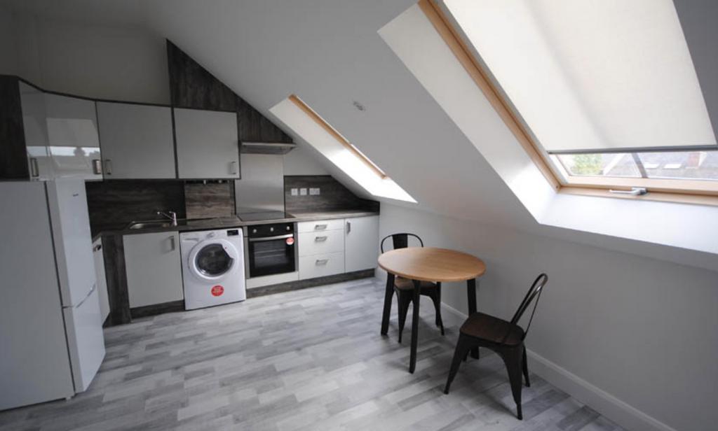 Bright and modern kitchen with ample natural li...