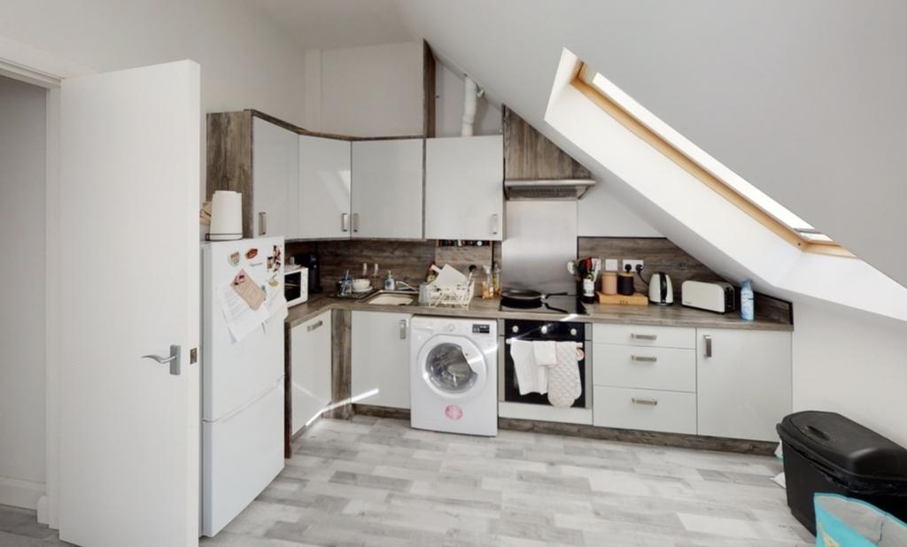 Bright and modern kitchen area with ample natur...