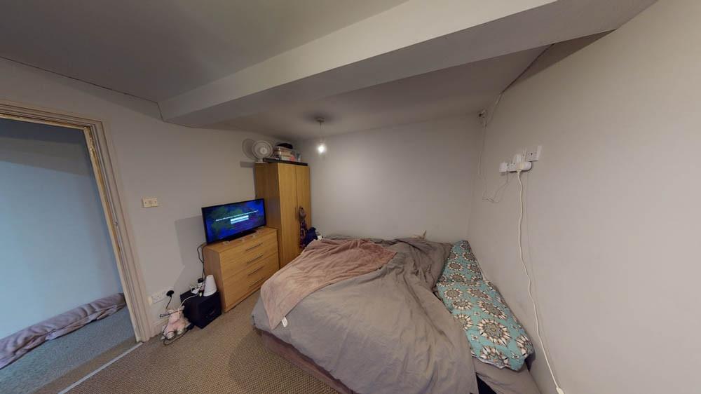 A cozy bedroom with a double bed topped with a ...