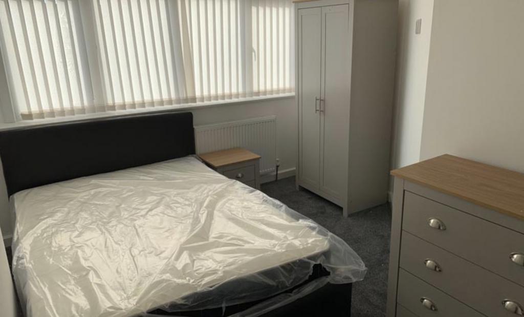A well-kept bedroom featuring a comfortable dou...