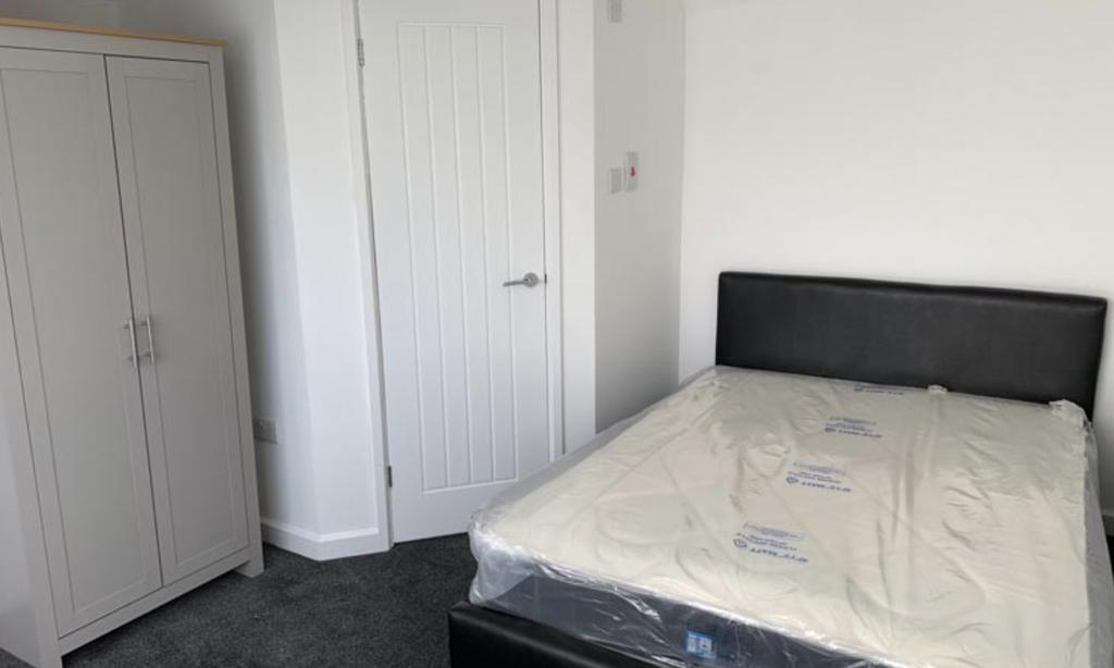 A neat and well-maintained bedroom featuring a ...