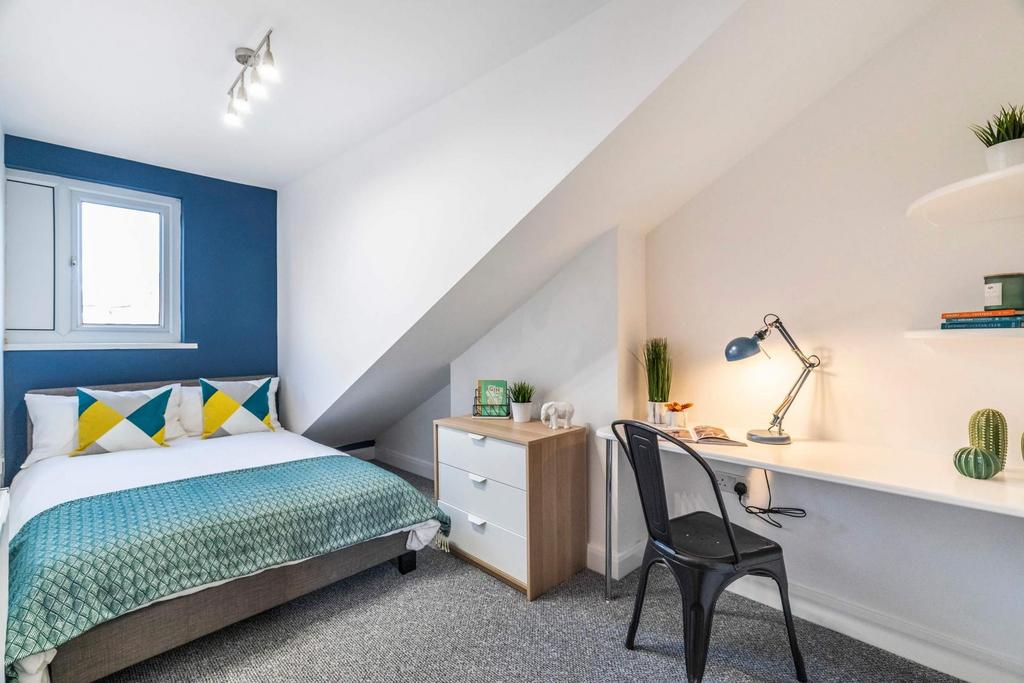 Bright and spacious master bedroom featuring a ...