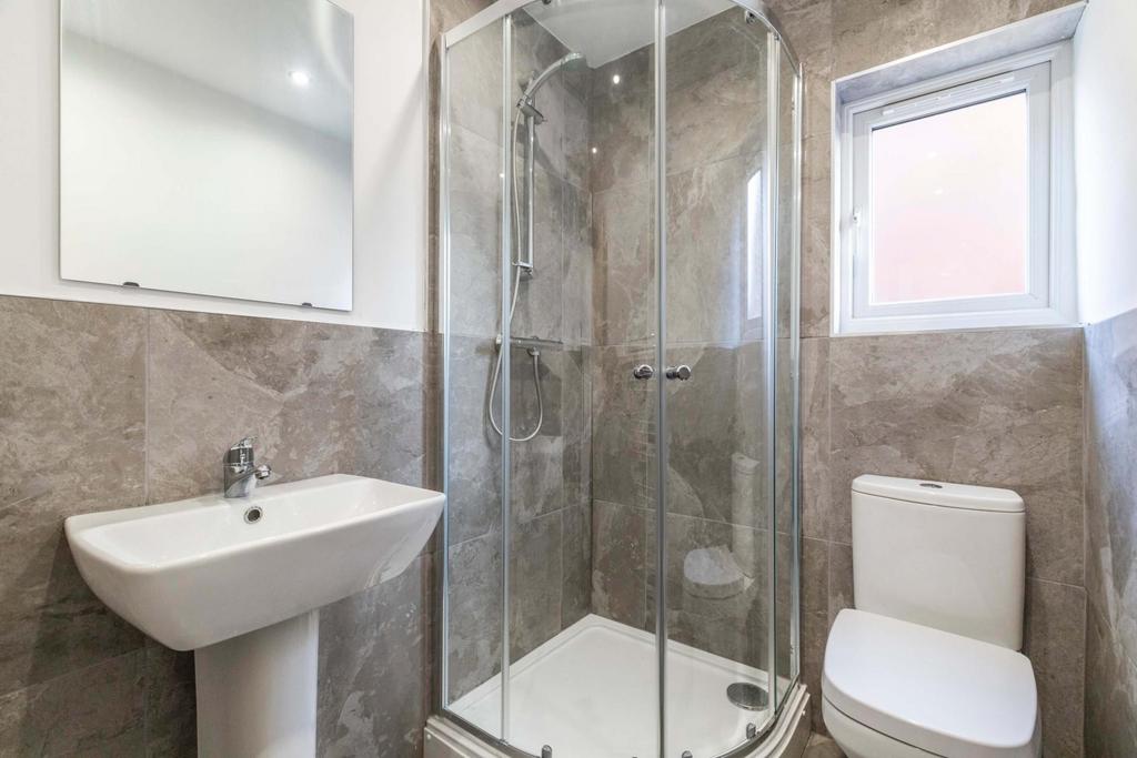 A spacious and modern bathroom suite featuring ...