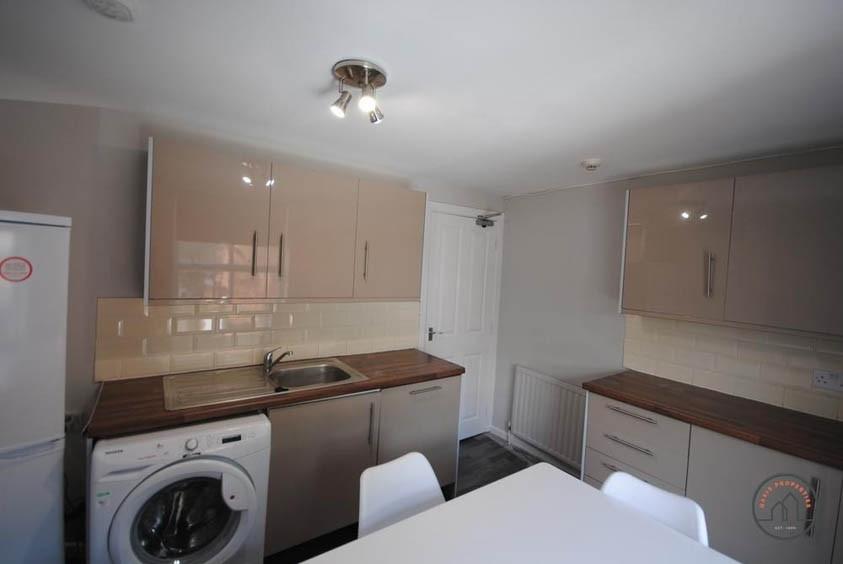 A modern, well-organized kitchen with ample wor...