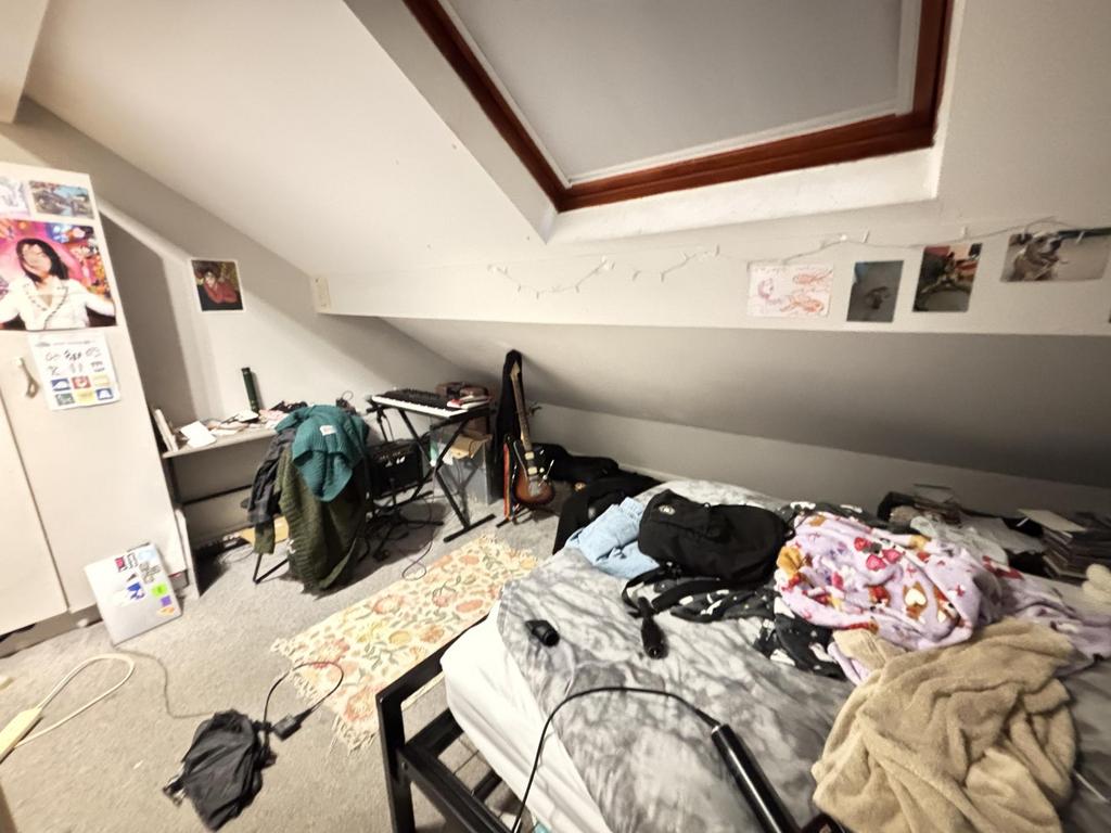 A spacious bedroom with a large bed, featuring ...