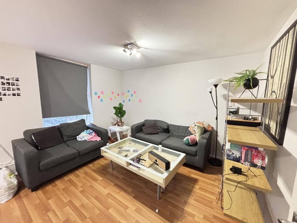 A bright and spacious living room featuring two...