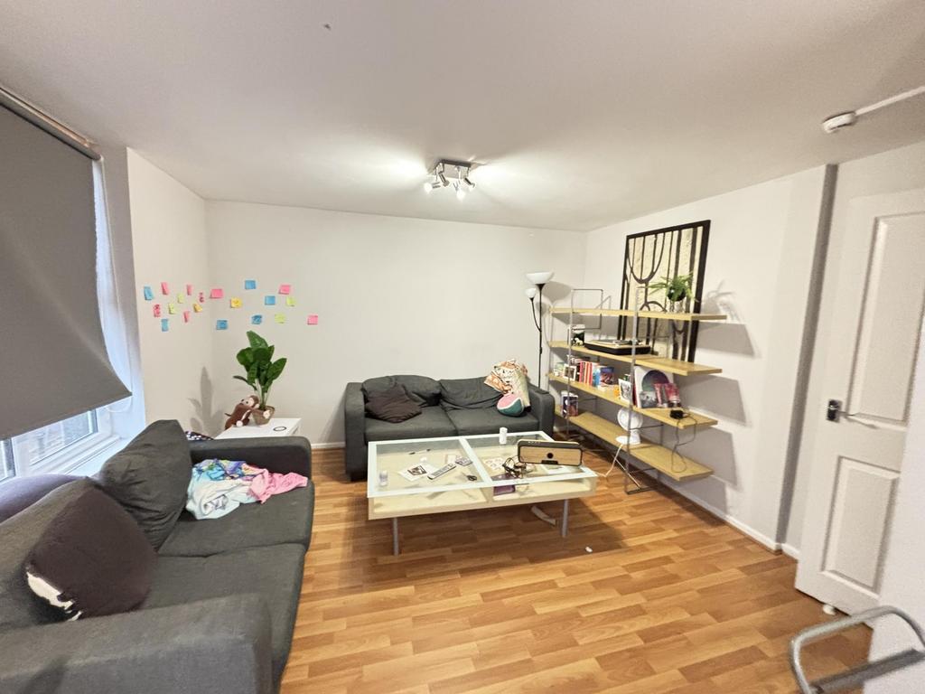 A spacious and well-lit living room featuring m...