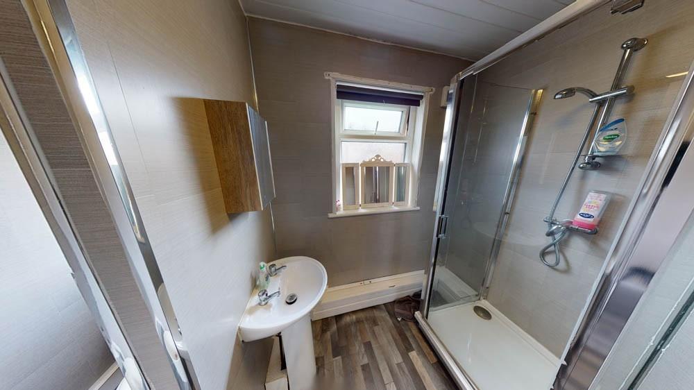 Bright and clean bathroom featuring a shower en...