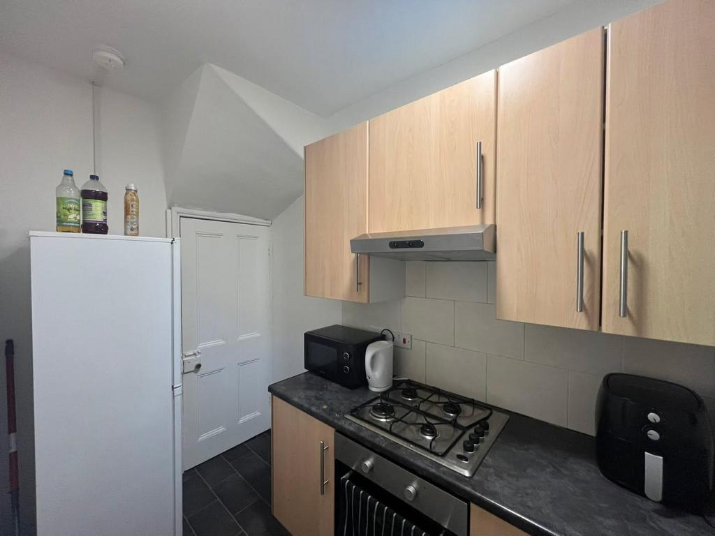 A modern kitchen with wooden cabinets, a white ...
