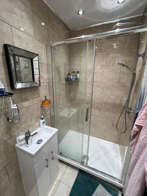 A clean and modern bathroom suite featuring a s...