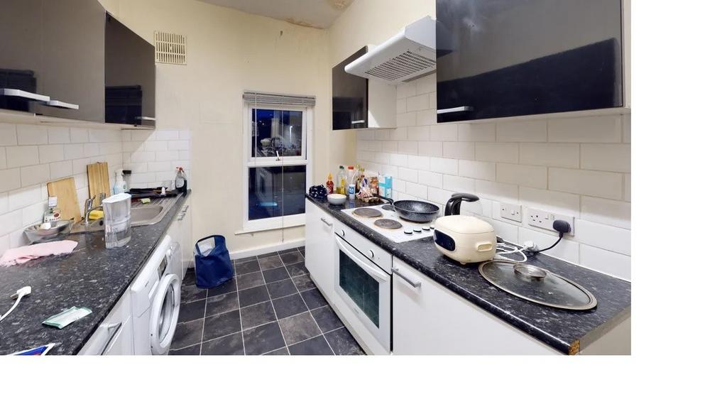 A modern, well-organized kitchen with sleek cab...