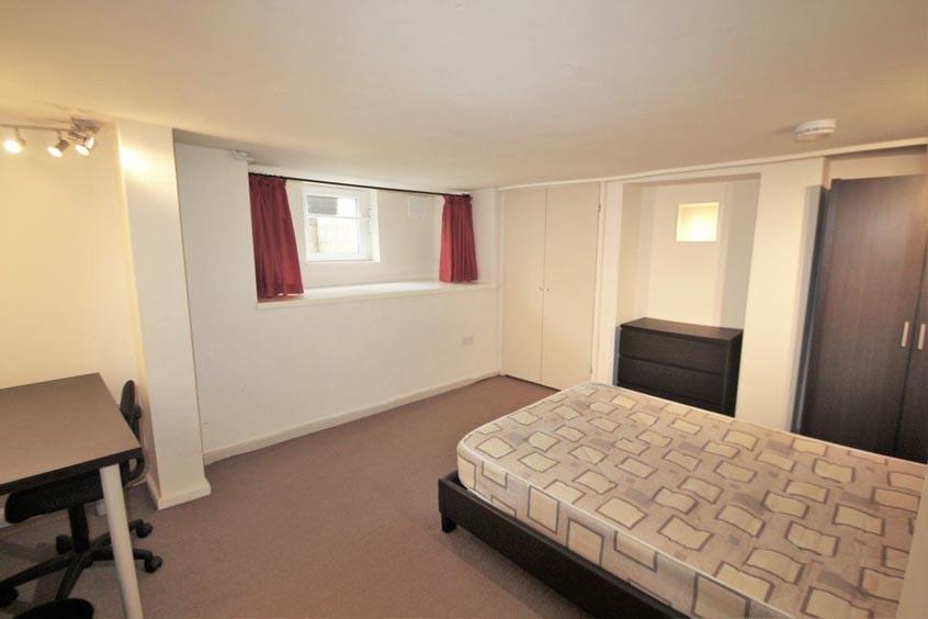 Bright and spacious master bedroom with comfort...