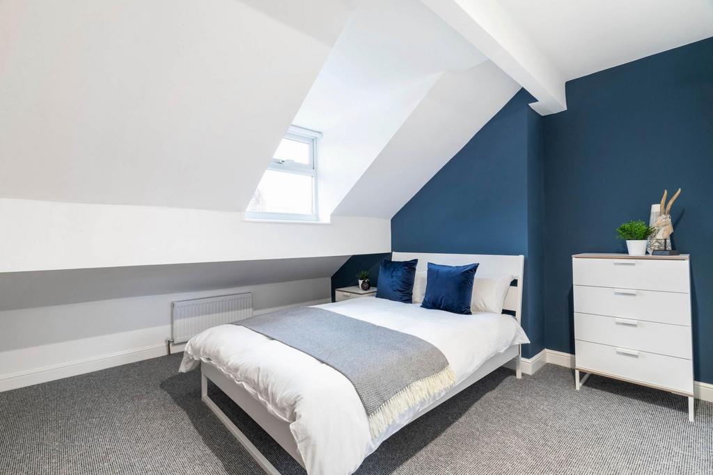 A bright and modern master bedroom featuring a ...