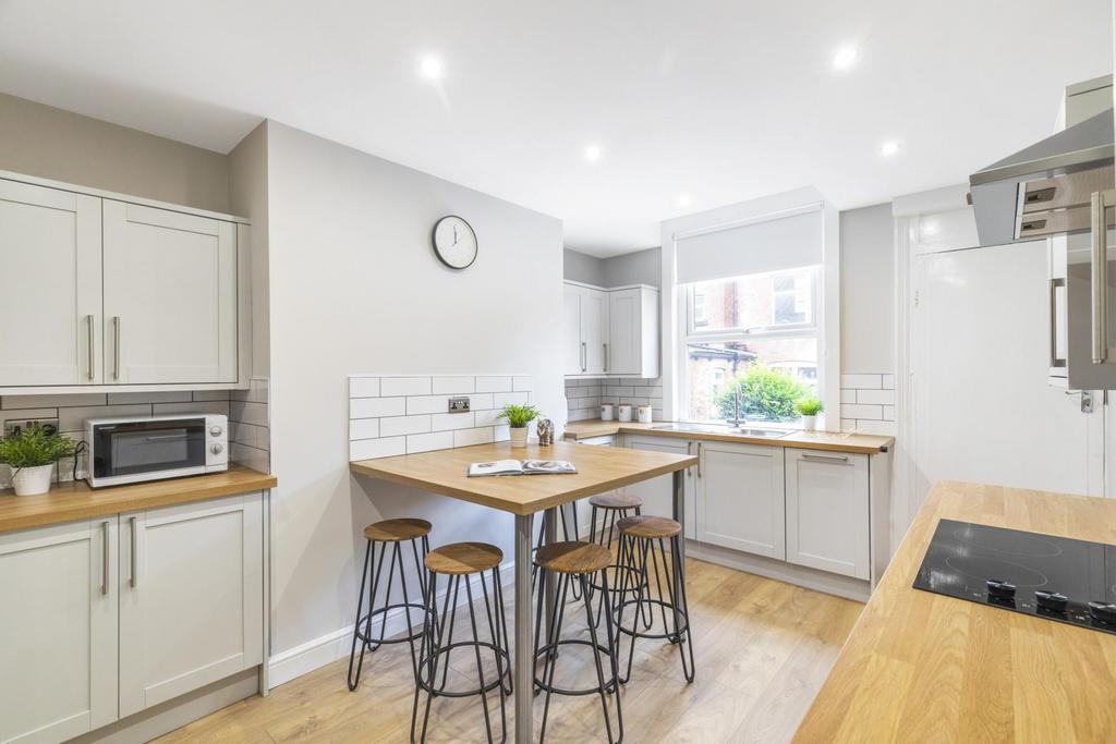 Bright and modern kitchen featuring ample natur...