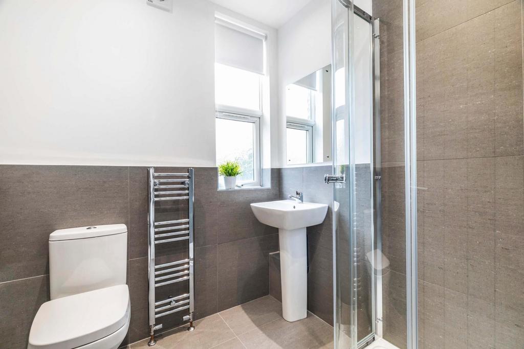 A clean and bright bathroom featuring a large b...