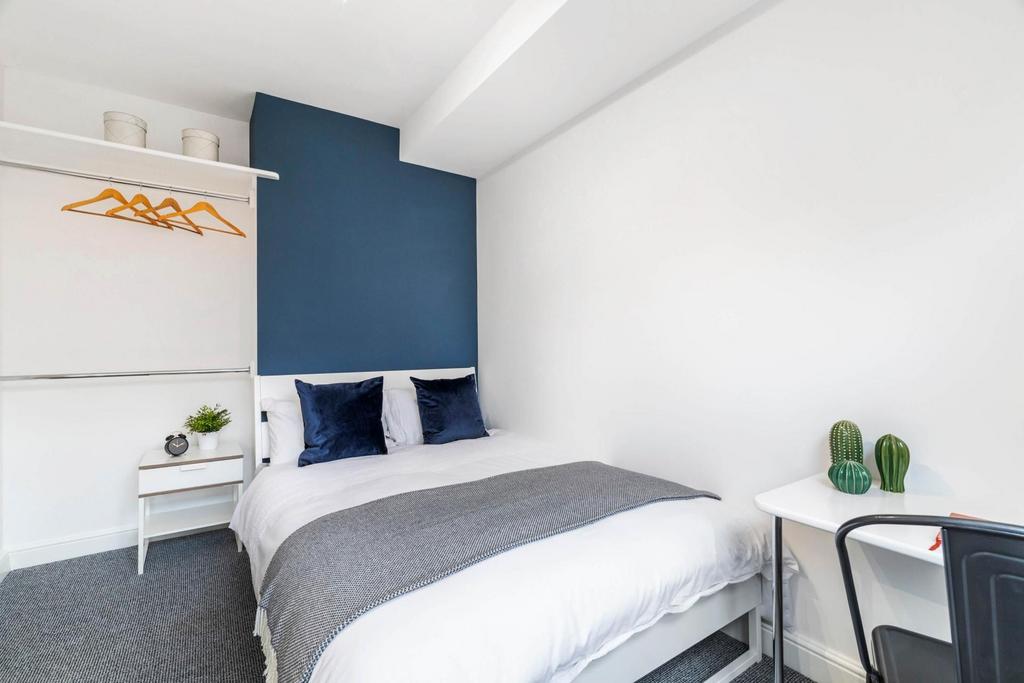 A spacious and well-lit double bedroom featurin...
