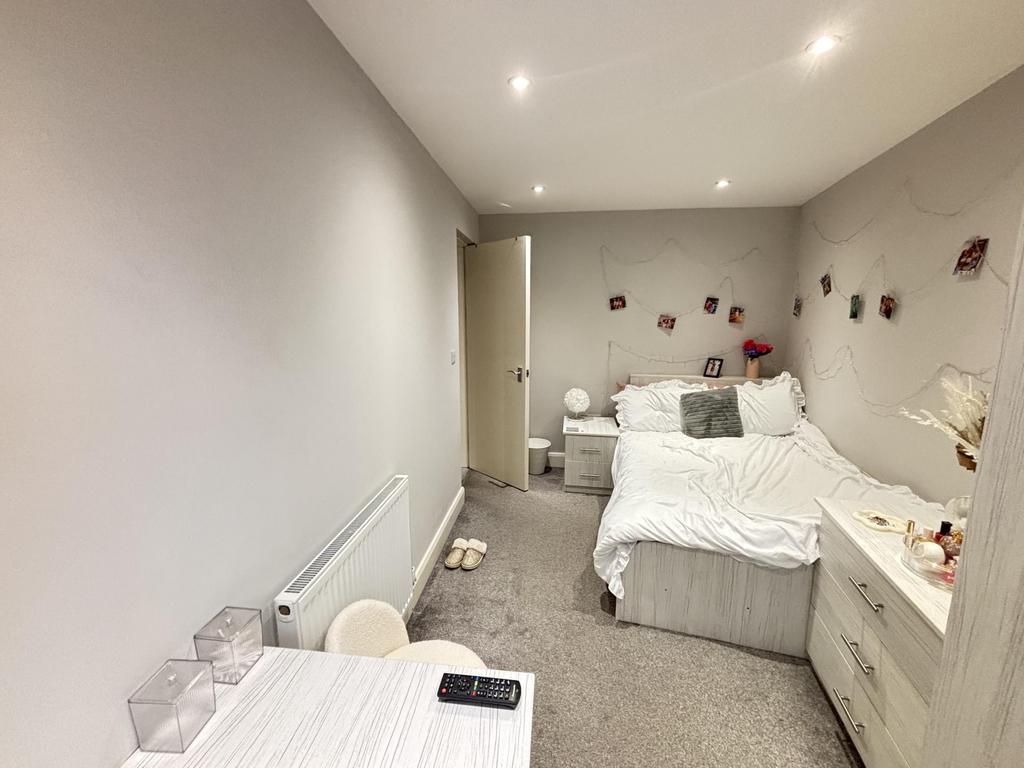 A well-maintained bedroom featuring a double be...