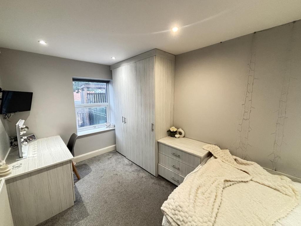 A well-maintained bedroom with a comfortable si...
