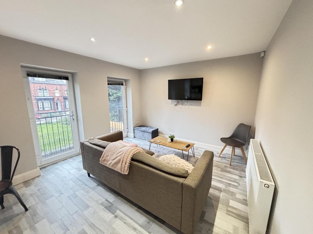 Bright and modern living room featuring a comfo...