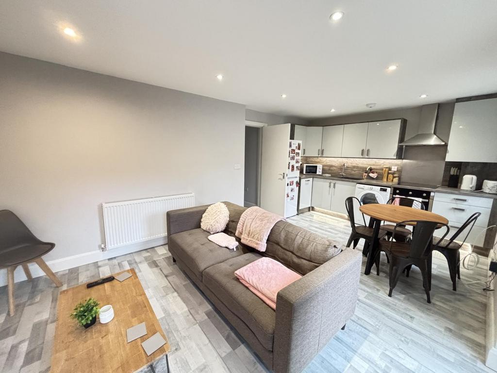 A bright and welcoming living room featuring mo...