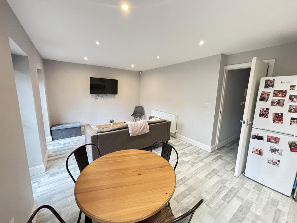A bright and modern living room featuring ample...