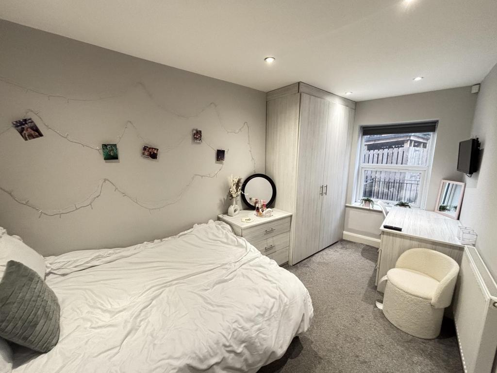 A bright and inviting double bedroom featuring ...