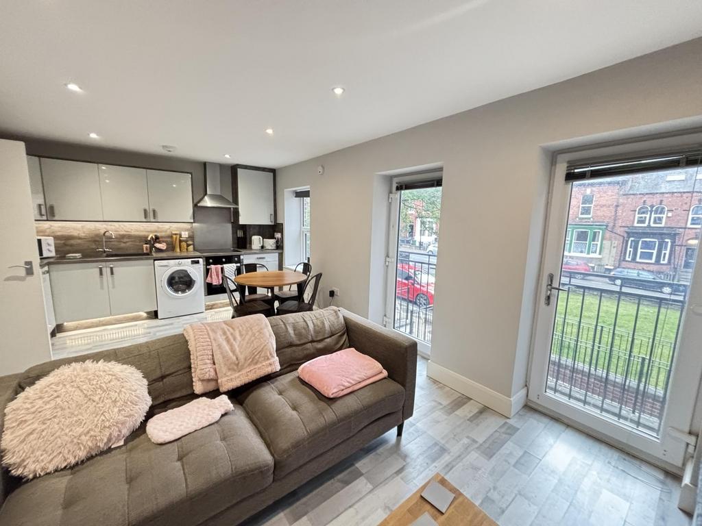 A bright and modern living room with ample natu...