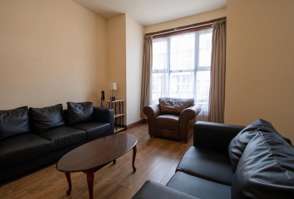 A spacious and cozy living room with comfortabl...