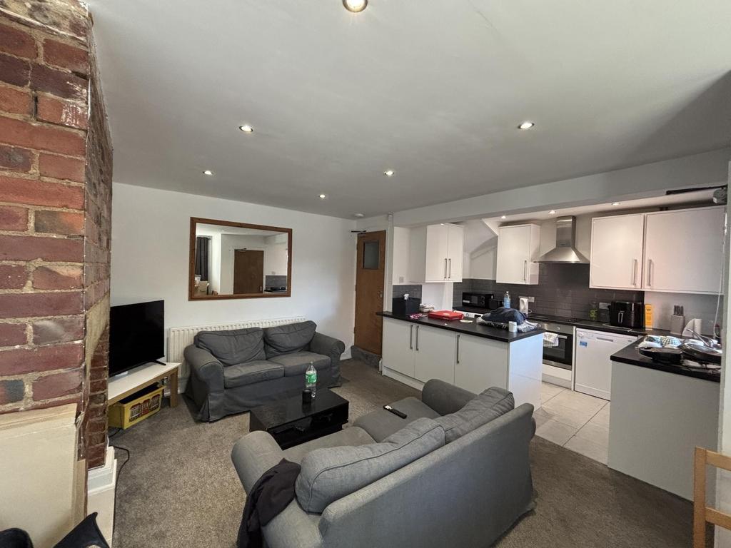 A spacious and well-lit living room with modern...