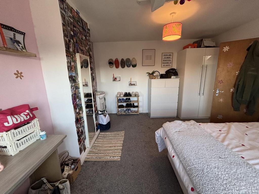A cozy bedroom featuring a comfortable bed, amp...