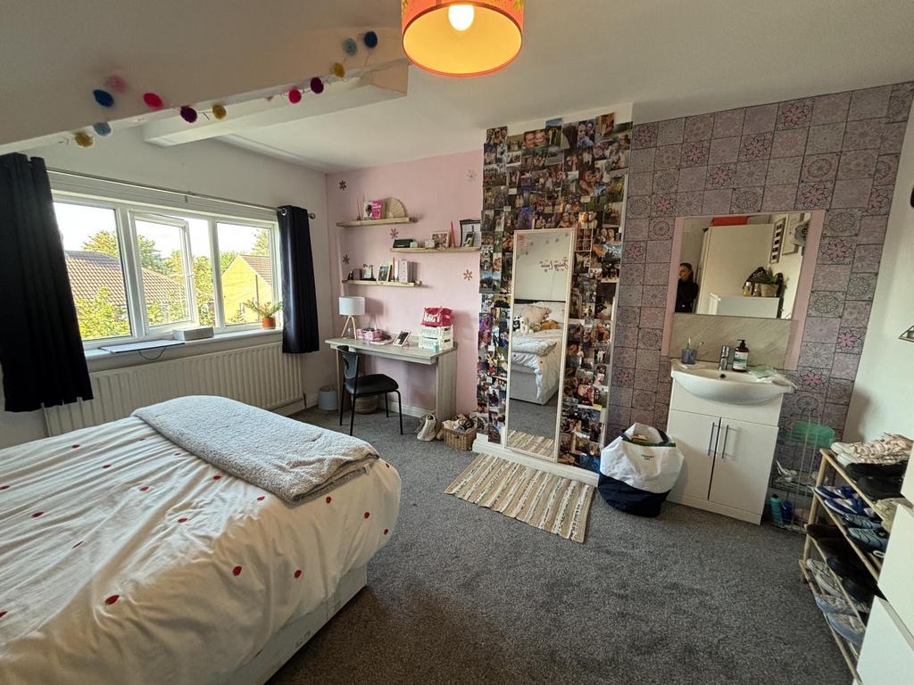 A bright and welcoming bedroom featuring a neat...