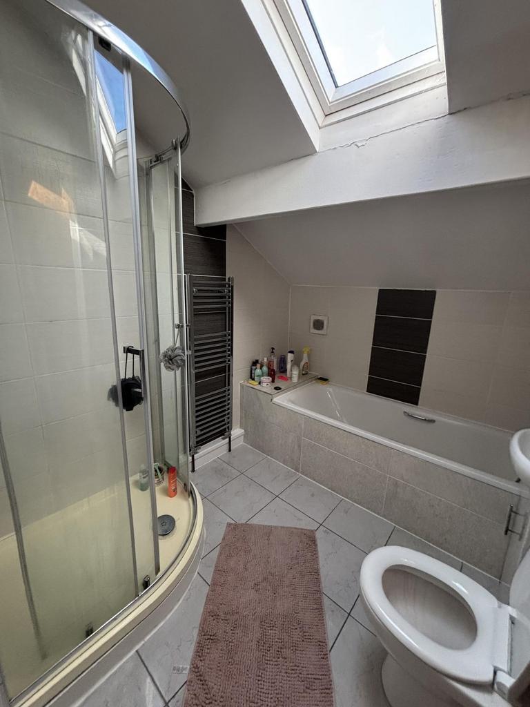 A modern bathroom featuring a large shower encl...