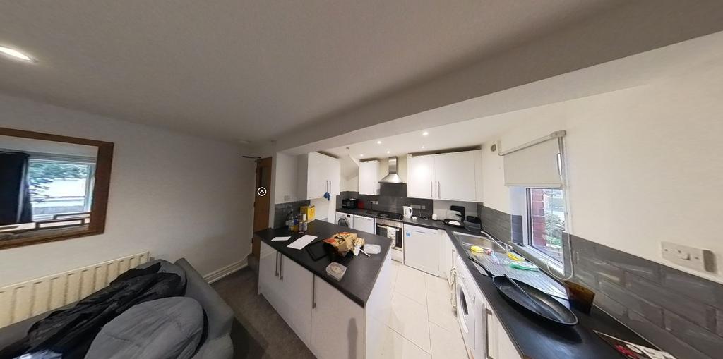 A modern kitchen featuring ample workspace, wel...