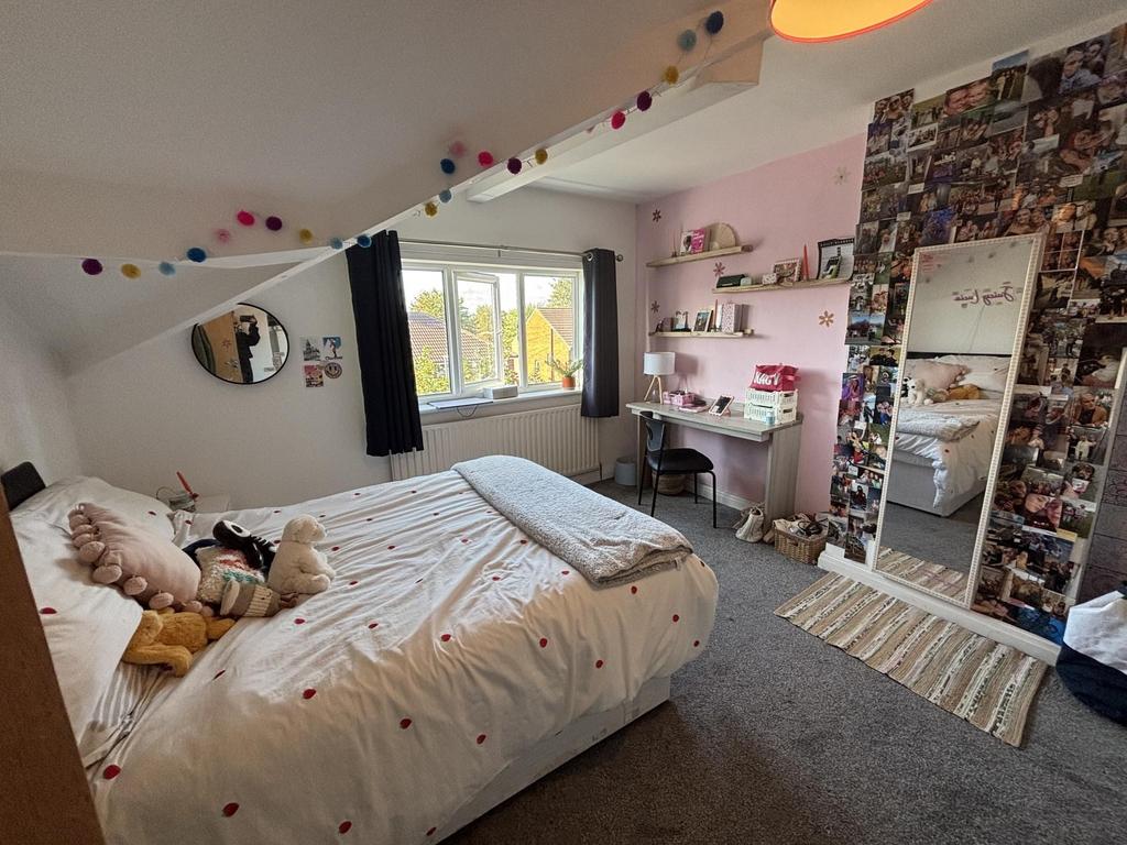 A cozy and bright bedroom featuring a comfortab...