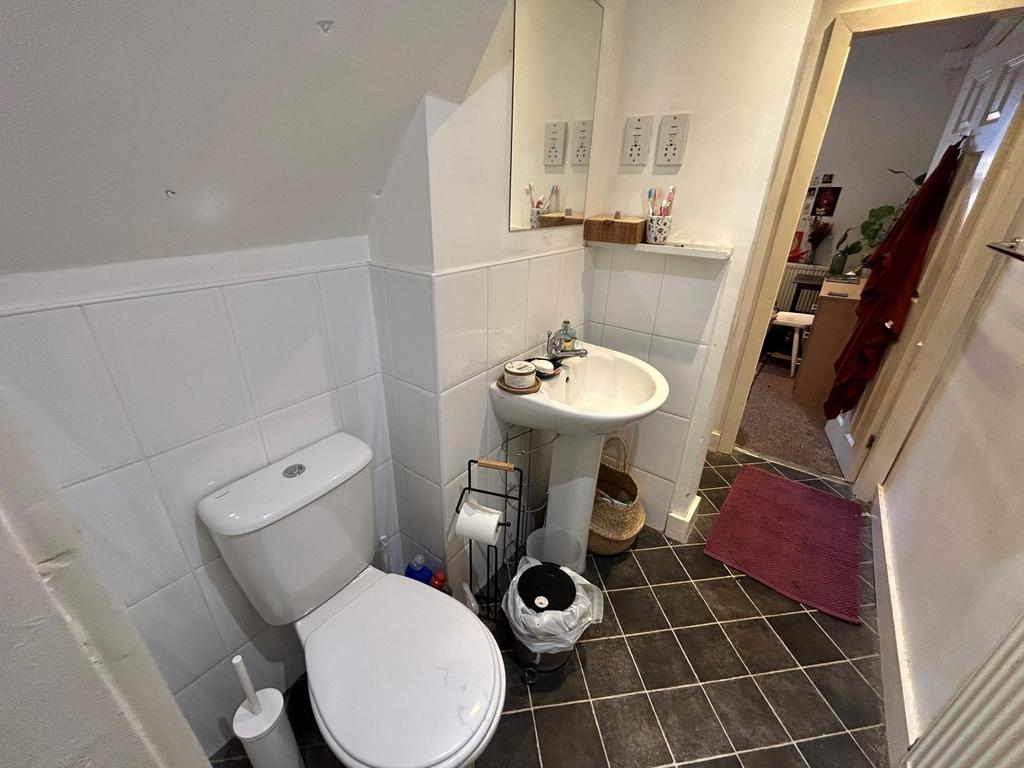 A functional bathroom featuring a toilet and a ...